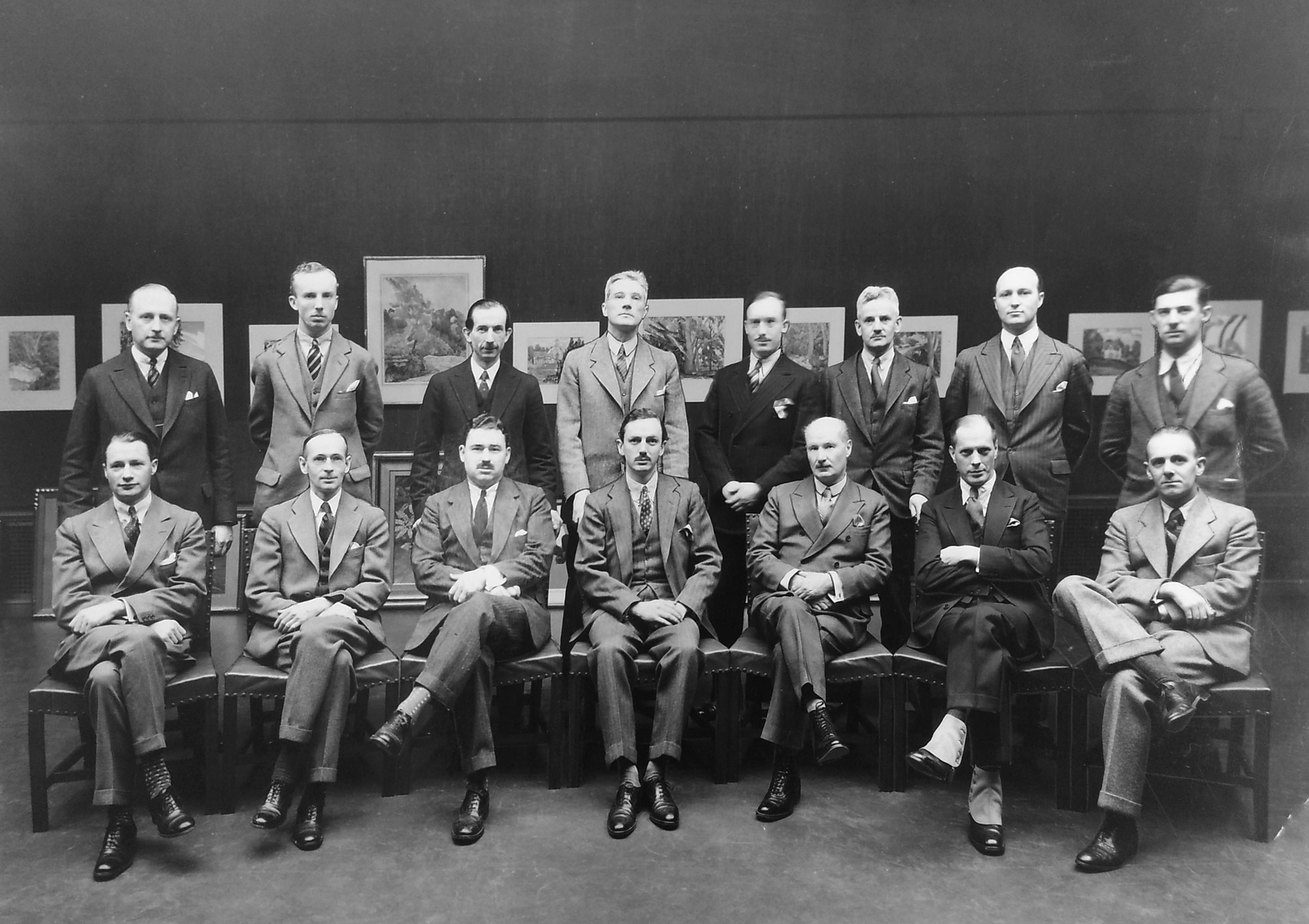 A portrait of the Committee in charge of the Fourth Biennial Architectural Exhibition of the Toronto Chapter of the Ontario Association of Architects. (Left to Right) Burwell R. Coon, Jack Ryrie, R.W. Catto, H.F. Secord, F.H. Wilkes, D.E. Kertland, G.R. Gouinlock, Dyce C. Saunders, L.C.M. Baldwin (Curator of Art Gallery), W.L. Somerville, A.S. Mathers (Chairman of Committee), D.M. Waters (Chairman of the Toronto Chapter of the Ontario Association of Architects), J.M. Lyle, Murray Brown and E.R. Arthurs.