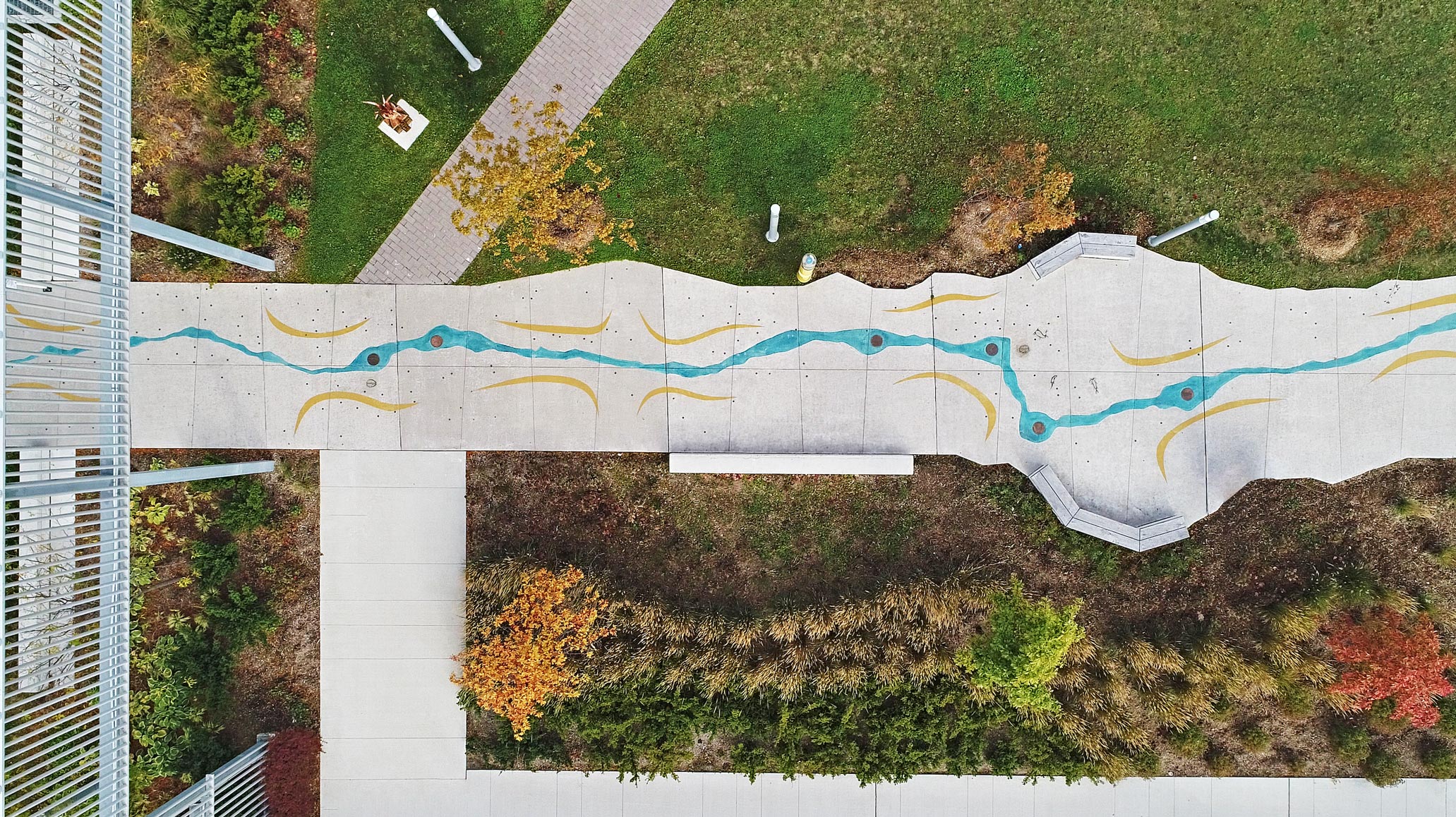 Tom Ridout, Courtesy of Brook McIlroy. The concrete leading to the Welcome Centre is coloured and patterned based on the seven stopping places of the Great Migration, of Anishnaabe Nations that moved westward along the Great Lakes to Lake Superior.