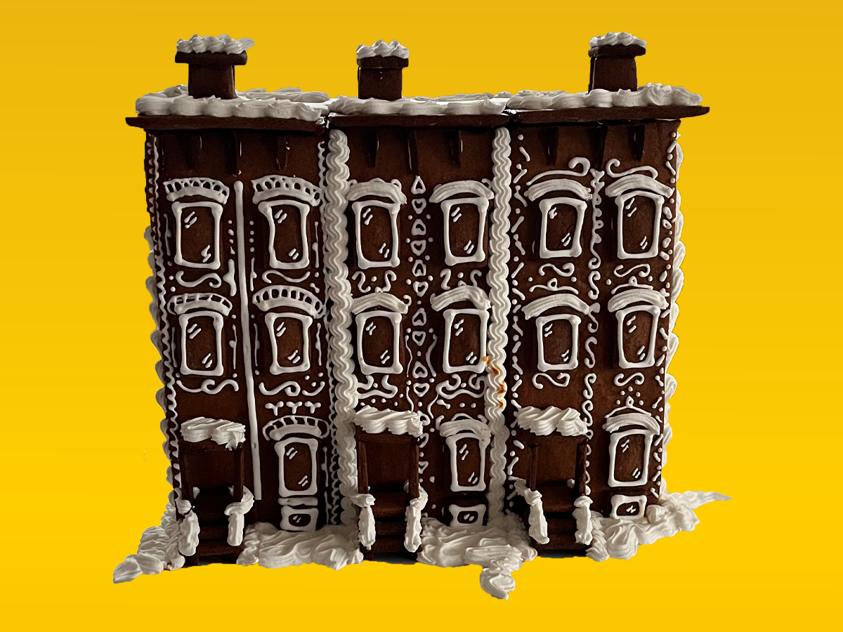 Three attached gingerbread row houses with white icing details.