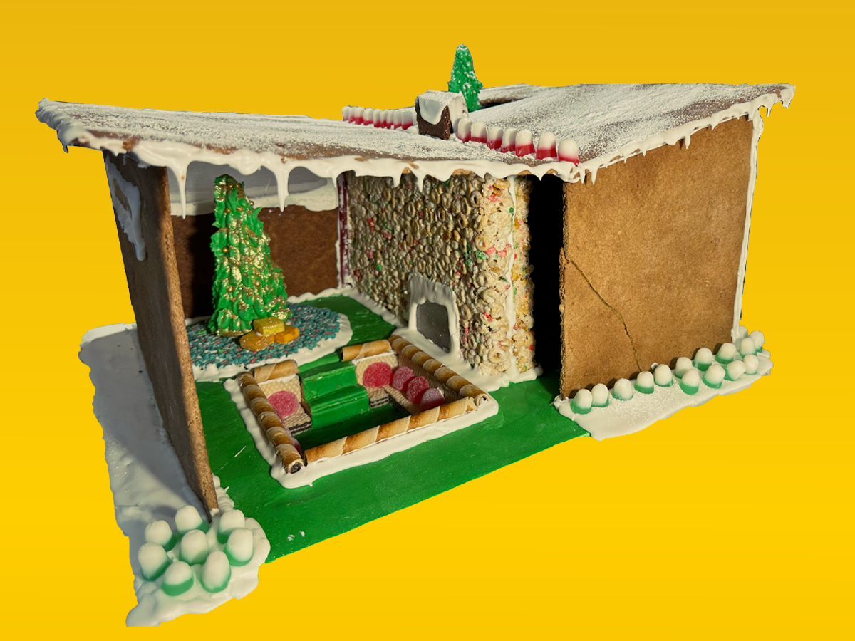 A mid-century home made of gingerbread with a visible interior living room.