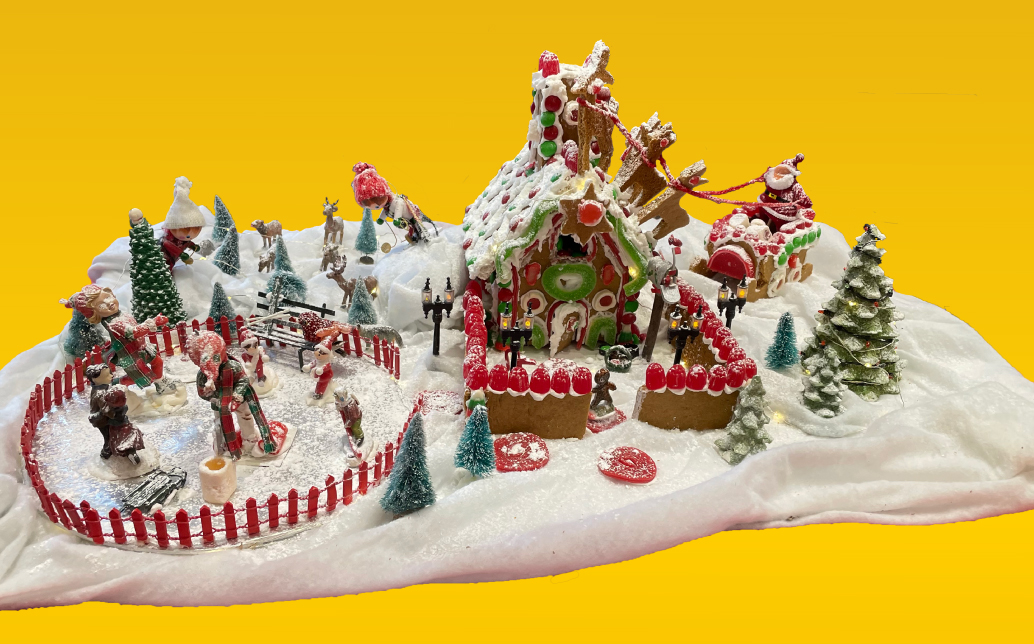 A busy holiday gingerbread village full of icing and candy.