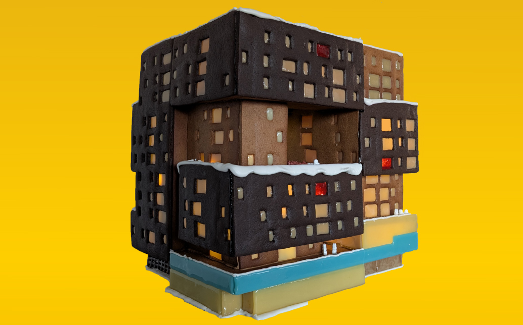 A complex mid-rise building made with differing colors of gingerbread.