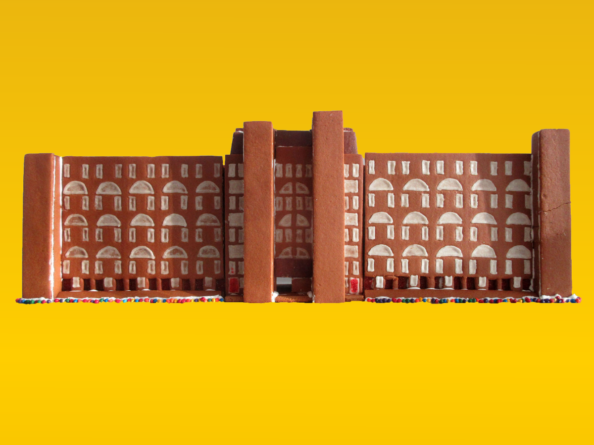 A mid-rise residential building made of gingerbread covered with iced windows.